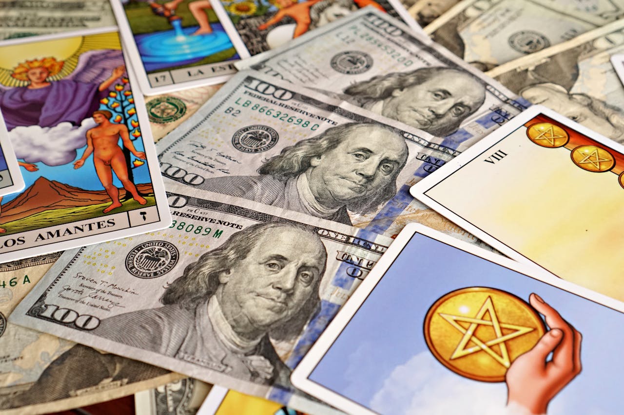 Combination of tarot cards and U.S. dollar bills symbolizing financial prosperity and mysticism.